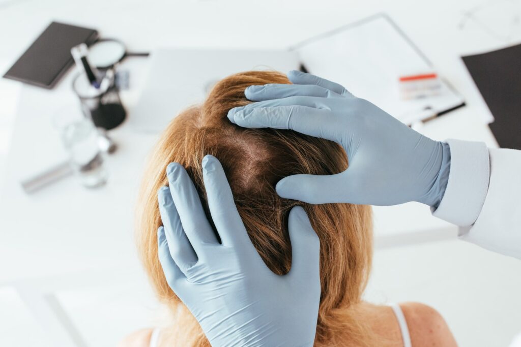 A dermatologist performing a scalp examination for PRP For Skin & Hair Loss
