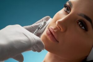 cosmetologist using botox injection for female face